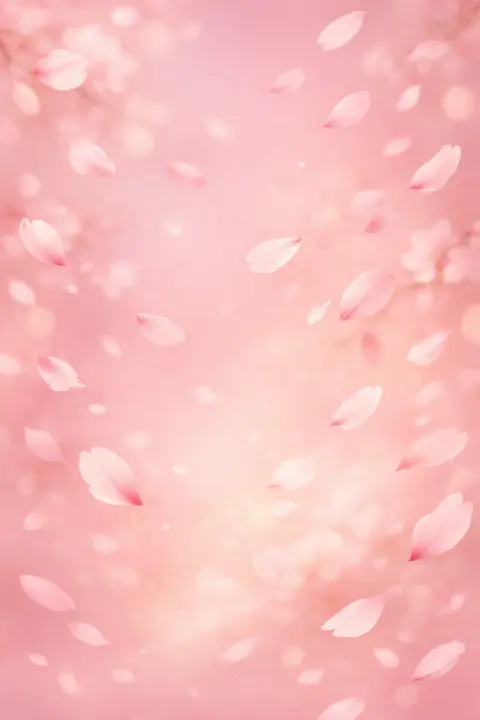 Pink wallpaper of cherry blossom petals drifting across a gradient sky